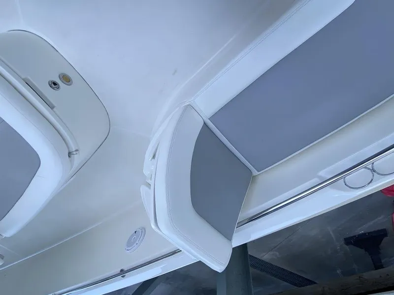 Slide: The Image of 2016 Boston Whaler 270 Dauntless interior seating, white and gray upholstery. - 11