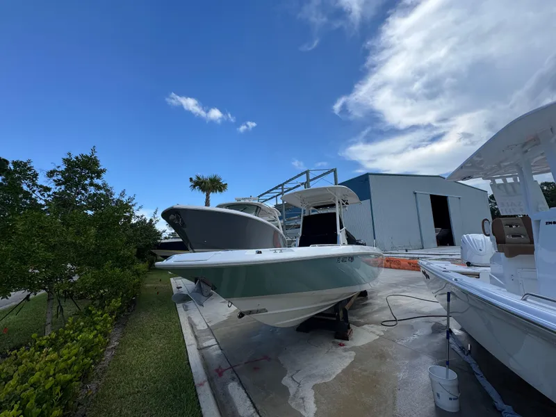 Slide: The Image of 2016 Boston Whaler 270 Dauntless boat on display at a marina under a blue sky. - 13