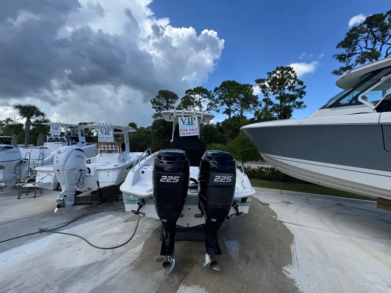 Slide: The Image of 2016 Boston Whaler 270 Dauntless with twin 225 engines, for sale under cloudy sky. - 15