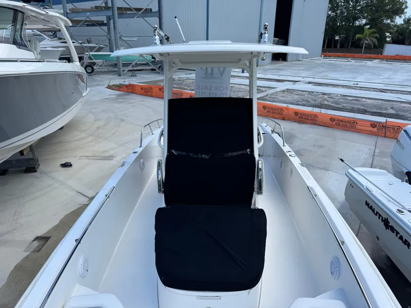 Slide: The Image of 2016 Boston Whaler 270 Dauntless boat with black seating, docked in a marina. - 19