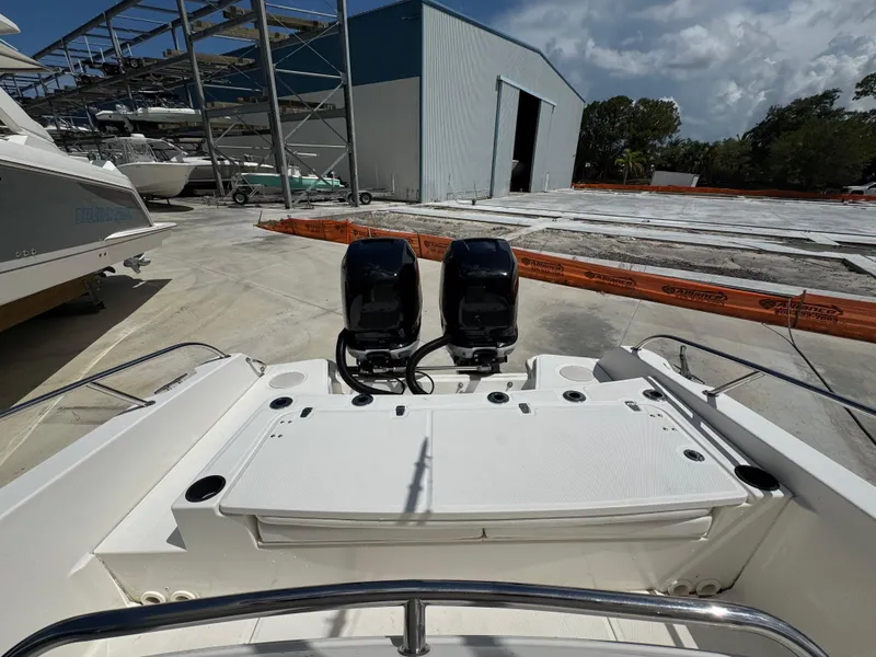 Slide: The Image of 2016 Boston Whaler 270 Dauntless boat with dual engines in a marina setting. - 21