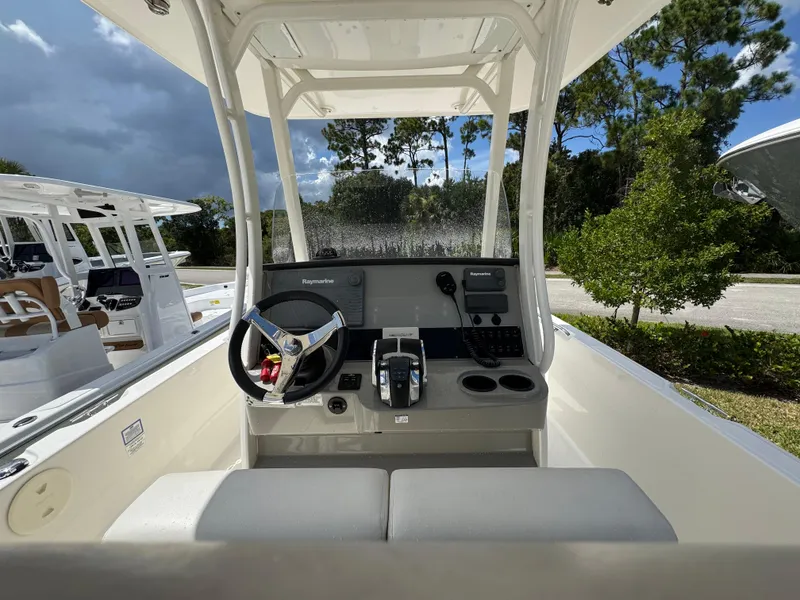 Slide: The Image of 2016 Boston Whaler 270 Dauntless boat console with steering wheel and controls. - 23