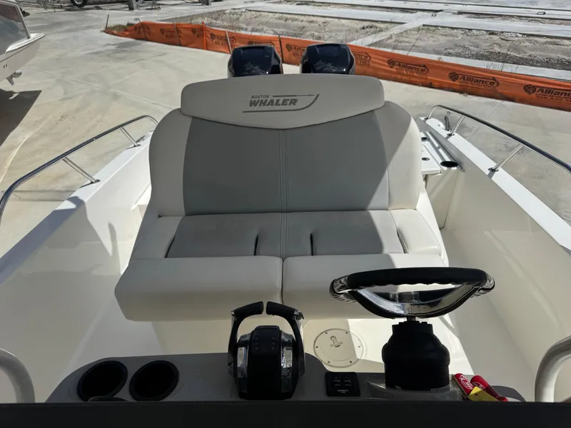 Slide: The Image of 2016 Boston Whaler 270 Dauntless boat interior with steering wheel and seating. - 24