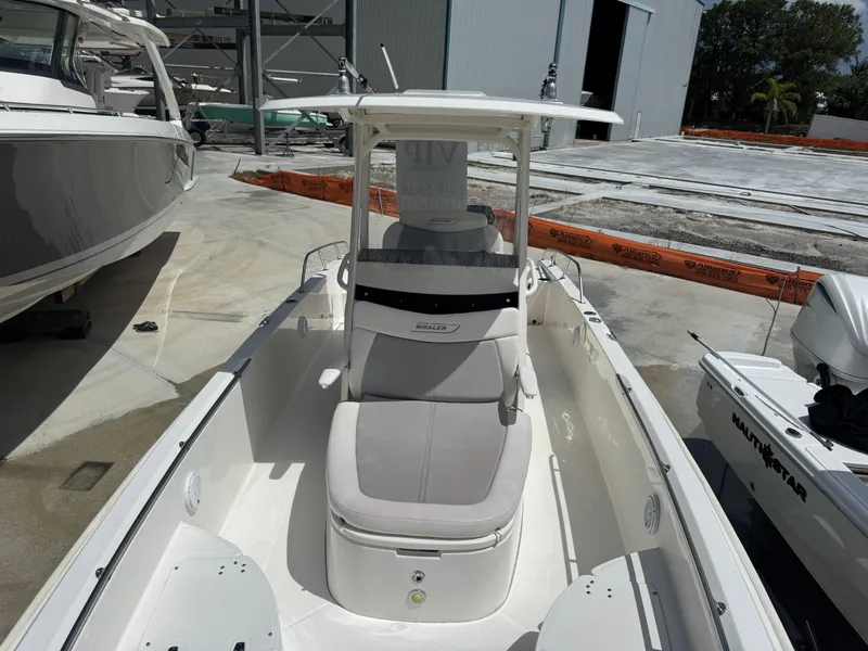 Slide: The Image of 2016 Boston Whaler 270 Dauntless boat docked in a marina setting. - 27