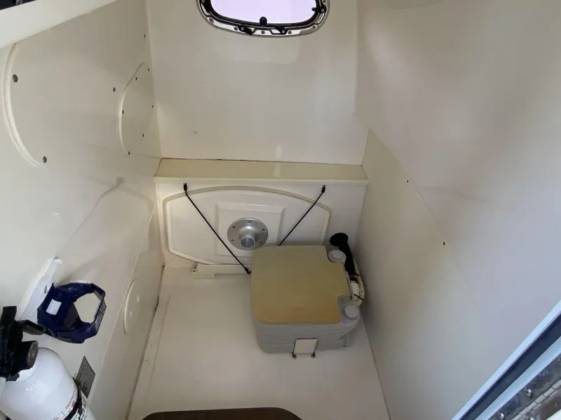 Slide: The Image of Interior cabin of 2016 Boston Whaler 270 Dauntless boat, featuring compact amenities. - 9