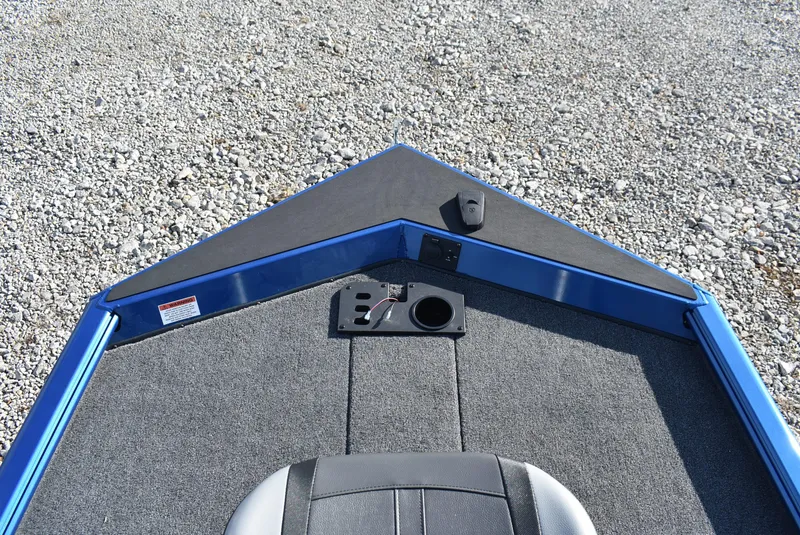 Slide: The Image of 2025 Lund 1775 Renegade SS boat interior with gray carpet and blue trim. - 10