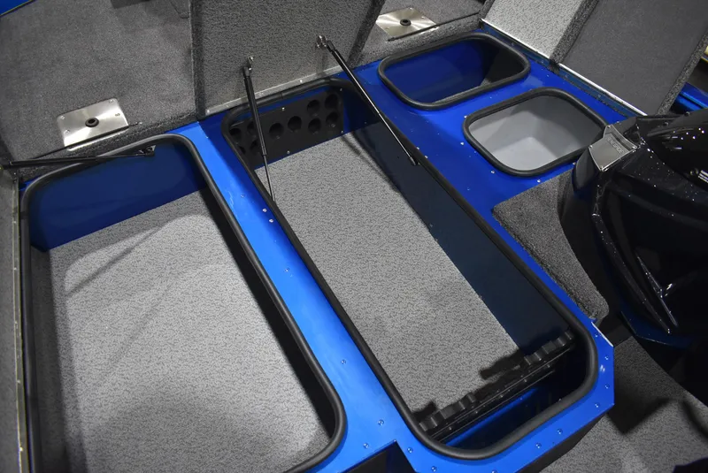 Slide: The Image of 2025 Lund 1775 Renegade SS boat storage compartments, open and spacious, with gray and blue interior. - 12
