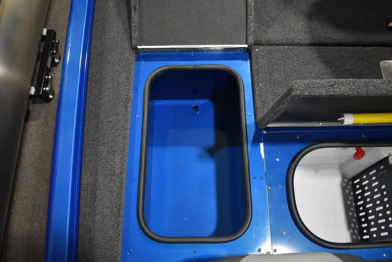 Slide: The Image of 2025 Lund 1775 Renegade SS boat storage compartments, featuring blue and gray interior design. - 17