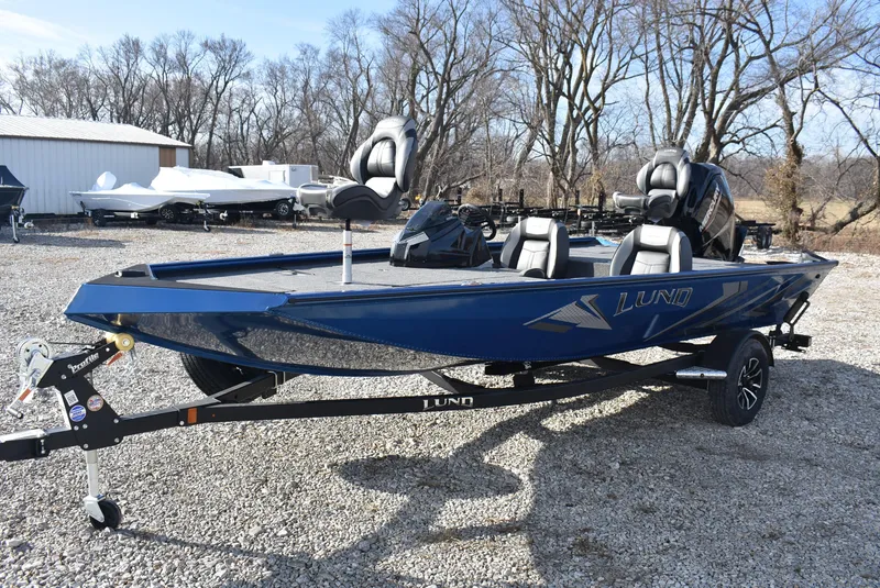 Slide: The Image of 2025 Lund 1775 Renegade SS fishing boat on trailer, parked outdoors. - 3