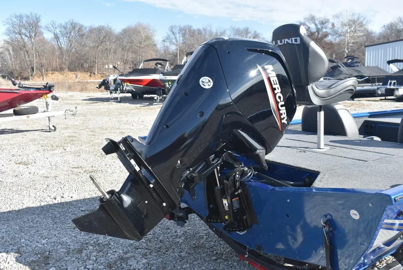 Slide: The Image of 2025 Lund 1775 Renegade SS boat with Mercury outboard motor in a marina setting. - 6