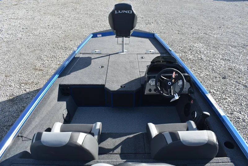 Slide: The Image of 2025 Lund 1775 Renegade SS boat interior with steering wheel and seating. - 7