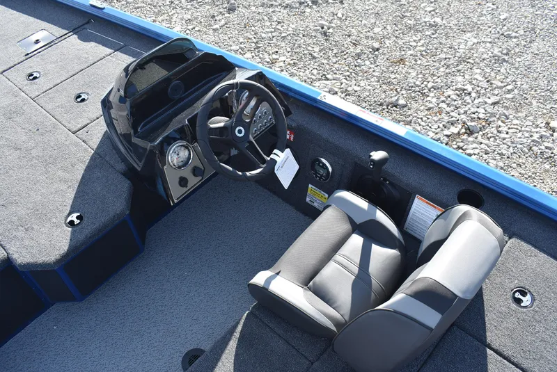 Slide: The Image of 2025 Lund 1775 Renegade SS boat interior with steering wheel and seating. - 8