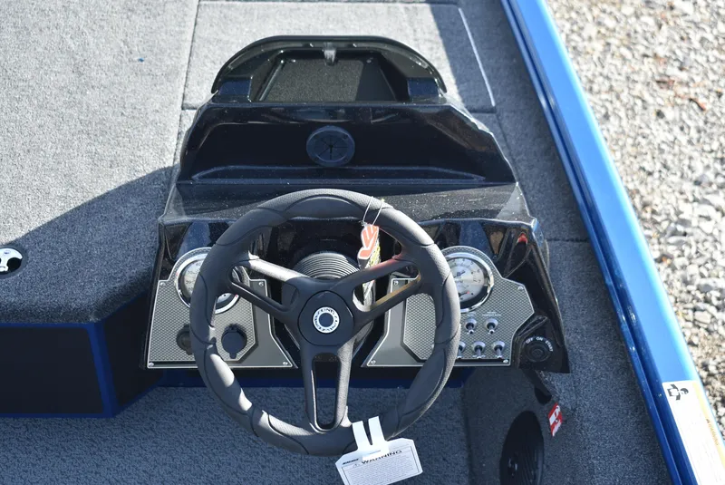 Slide: The Image of 2025 Lund 1775 Renegade SS boat dashboard with steering wheel and controls. - 9