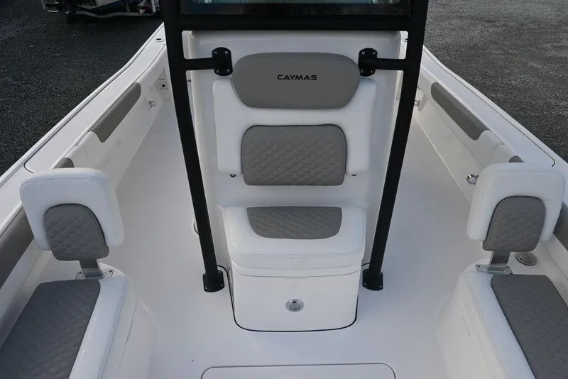Slide: The Image of 2025 Caymas 26 HB boat interior with gray and white seating. - 12