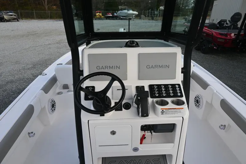Slide: The Image of 2025 Caymas 26 HB boat console with Garmin displays and steering wheel. - 15
