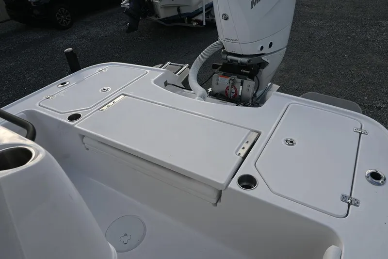Slide: The Image of 2025 Caymas 26 HB boat deck with storage compartments and motor. - 16