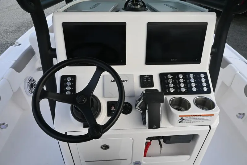 Slide: The Image of 2025 Caymas 26 HB boat dashboard with dual screens and steering wheel. - 19