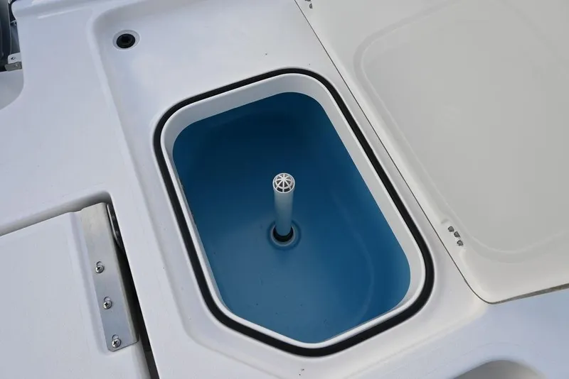 Slide: The Image of Livewell compartment on 2025 Caymas 26 HB boat, featuring a blue interior. - 24