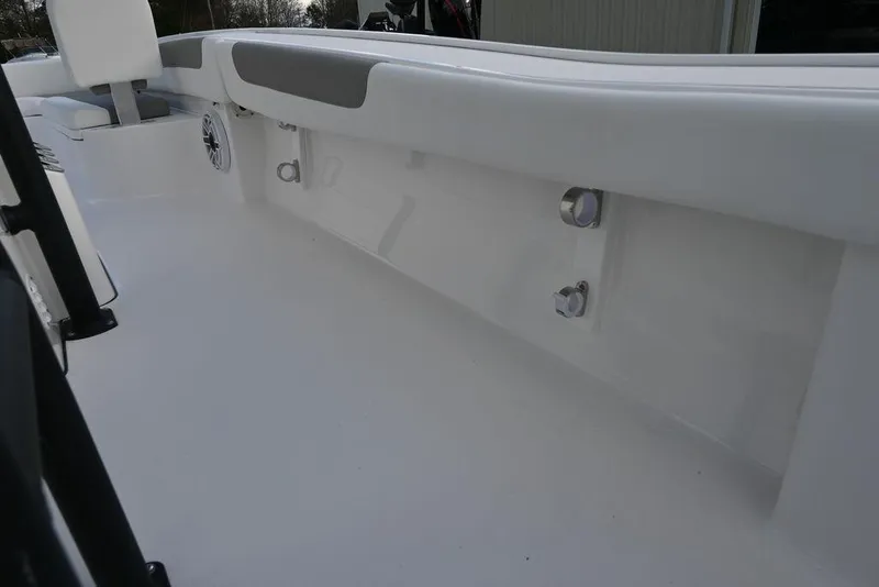 Slide: The Image of 2025 Caymas 26 HB boat interior with sleek white design and seating. - 26