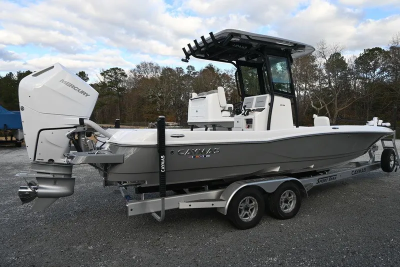Slide: The Image of 2025 Caymas 26 HB boat on trailer with Mercury engine, parked outdoors. - 3
