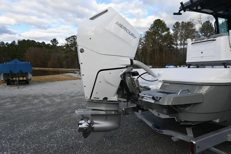 Slide: The Image of 2025 Caymas 26 HB boat with Mercury outboard motor on trailer. - 7