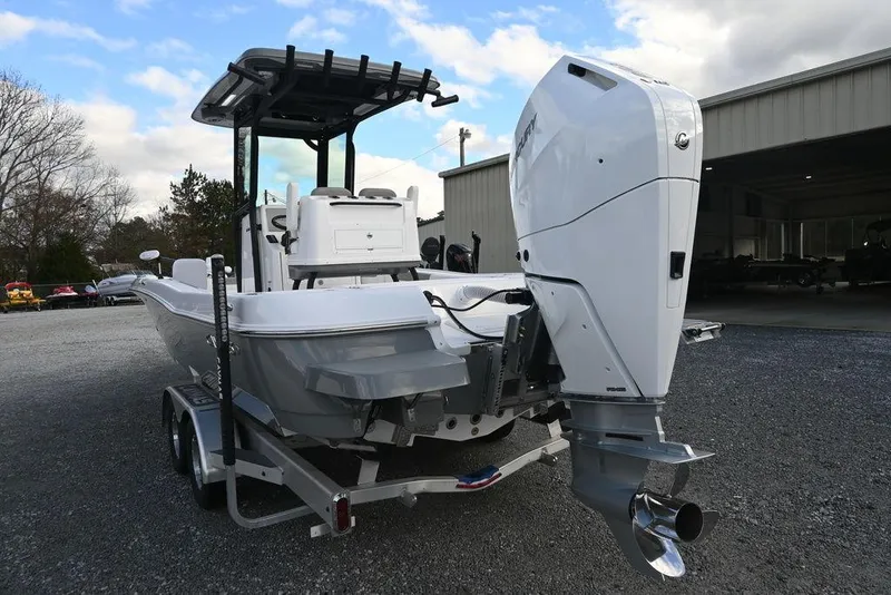 Slide: The Image of 2025 Caymas 26 HB boat on trailer, parked outdoors. - 8