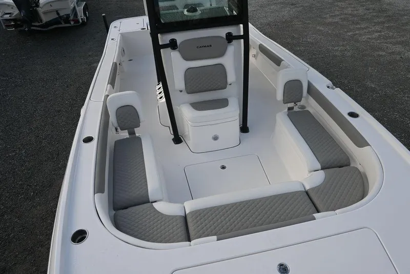 Slide: The Image of 2025 Caymas 26 HB boat interior with gray cushioned seating and center console. - 9