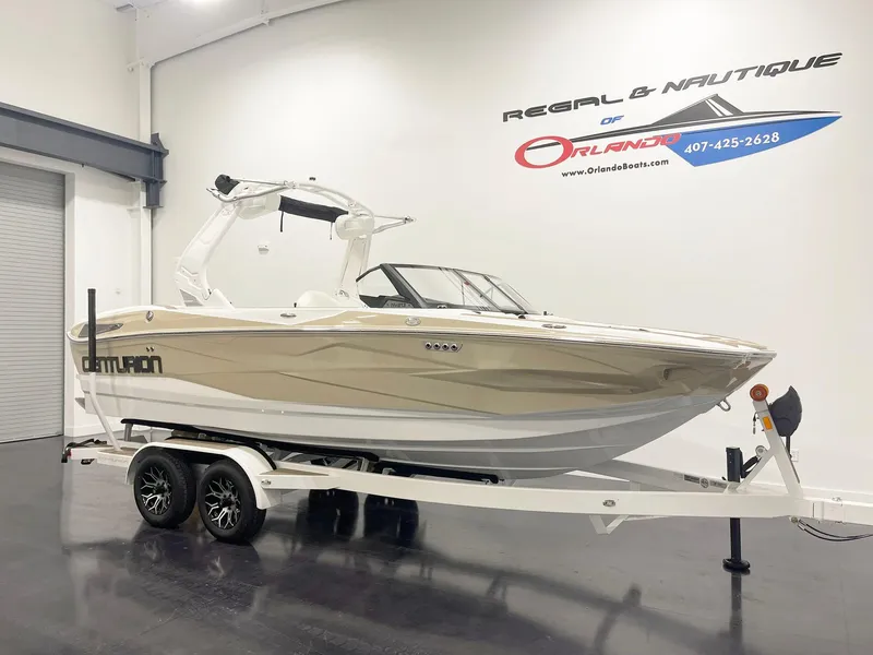 The Image of 2025 Centurion NV213 boat on trailer in showroom, side view. - 0