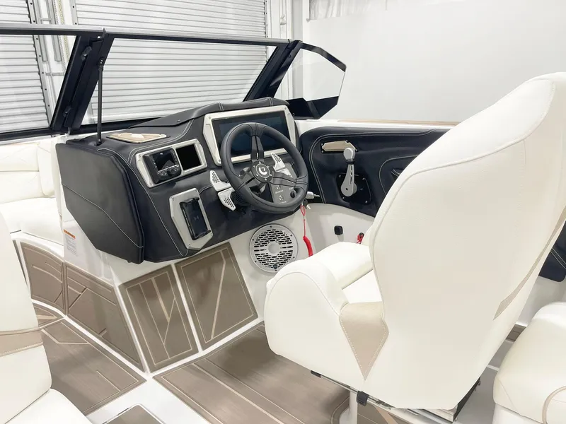 Slide: The Image of 2025 Centurion NV213 boat interior with modern dashboard and white seating. - 10