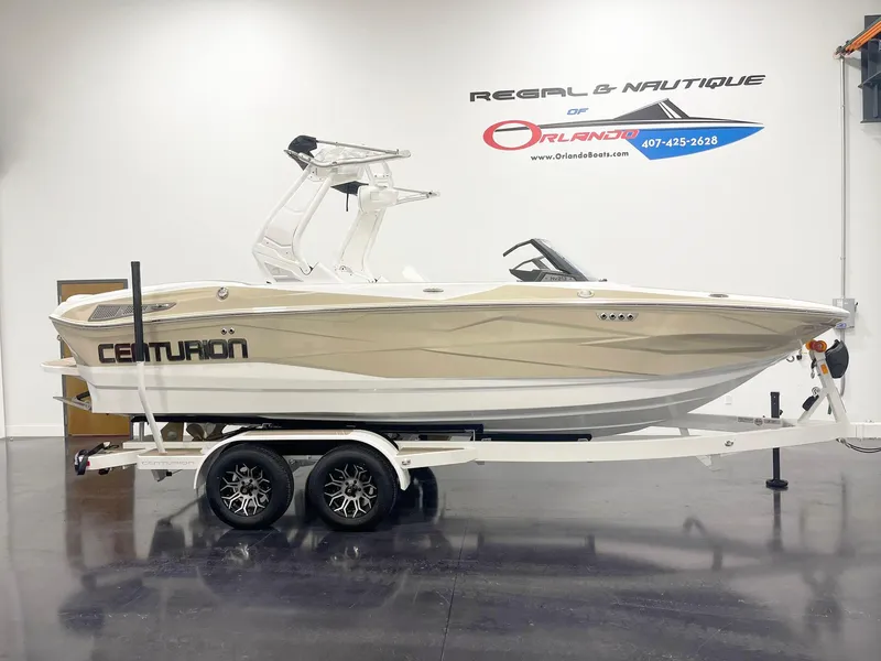 Slide: The Image of 2025 Centurion NV213 boat on trailer in showroom. - 2
