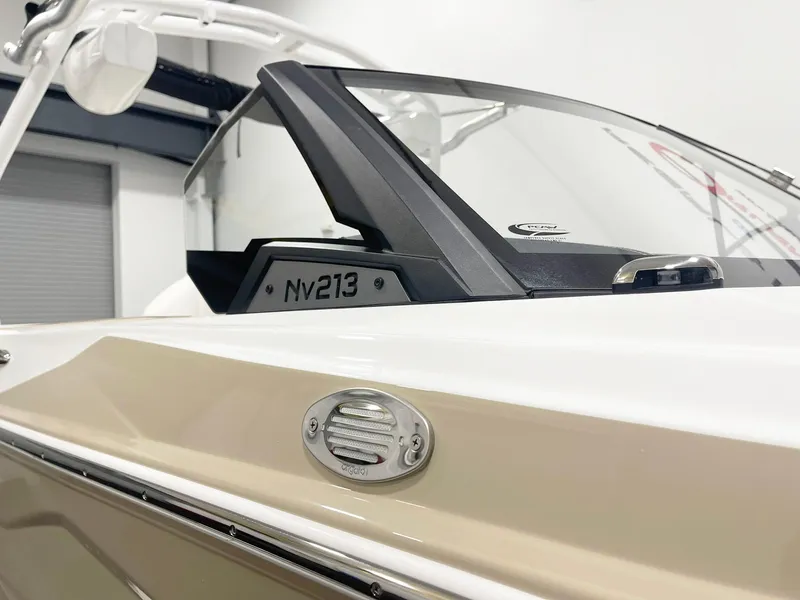 Slide: The Image of Centurion NV213 2025 boat, close-up of windshield and side detail in showroom. - 3
