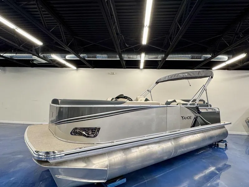 Slide: The Image of 2025 Tahoe LTZ 2385 CRB pontoon boat in showroom, sleek design, modern features. - 1
