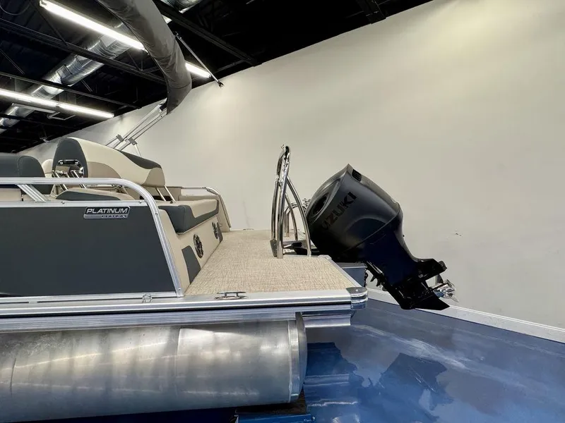 Slide: The Image of 2025 Tahoe LTZ 2385 CRB pontoon boat with Suzuki outboard motor in showroom. - 3
