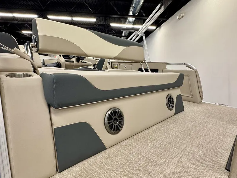 Slide: The Image of 2025 Tahoe LTZ 2385 CRB boat interior with beige and gray seating, cup holder, and speaker. - 6