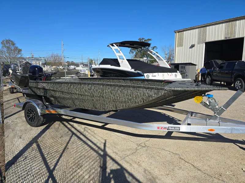 Slide: The Image of 2025 Edge Duck Boats 753 DB on trailer, parked outdoors under clear blue sky. - 2