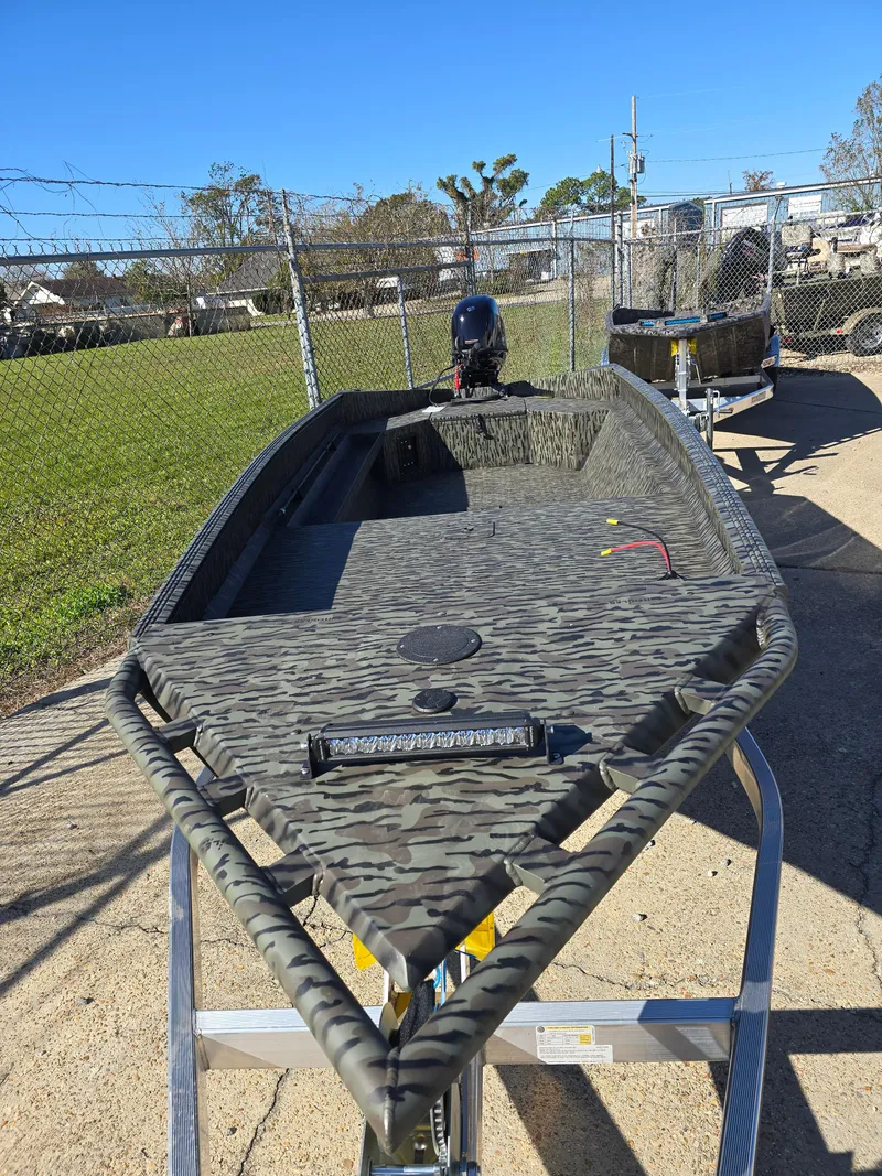 Slide: The Image of 2025 Edge Duck Boats 753 DB in camouflage design, parked outdoors. - 6