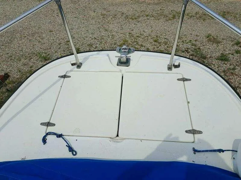 Slide: The Image of 1973 Boston Whaler 21 Outrage boat deck with storage hatches and railing. - 16