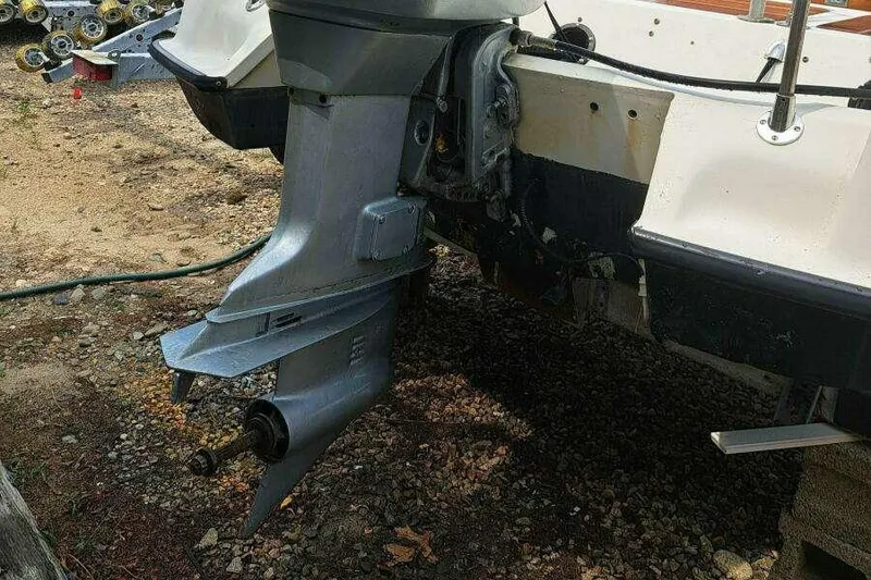 Slide: The Image of 1973 Boston Whaler 21 Outrage boat with visible outboard motor and hull details. - 18