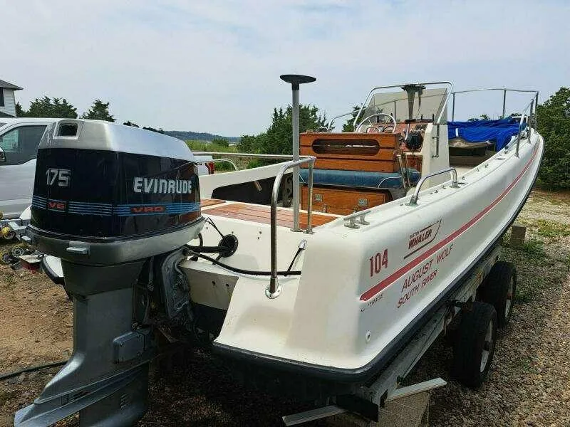 Slide: The Image of 1973 Boston Whaler 21 Outrage boat with Evinrude 175 V6 engine on trailer. - 2