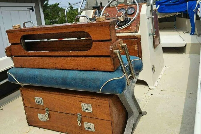 Slide: The Image of 1973 Boston Whaler 21 Outrage boat interior with wooden console and blue cushioned seat. - 5