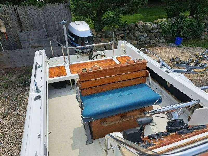 Slide: The Image of 1973 Boston Whaler 21 Outrage boat with wooden seating and V6 engine. - 7