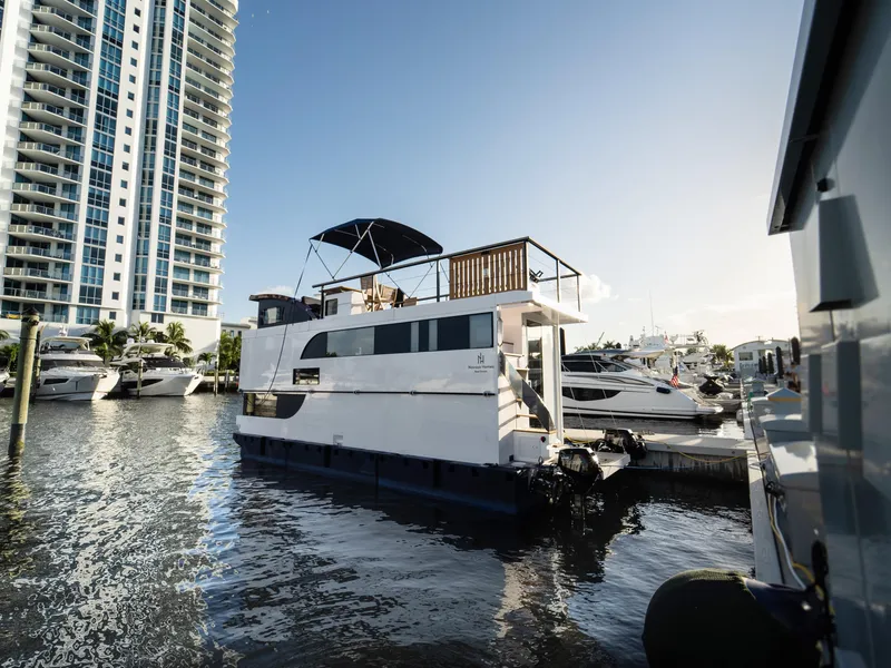 Slide: The Image of Modern 2024 Navisyo Homes 28' NAVIS V.08 houseboat docked in marina, sunny day. - 21