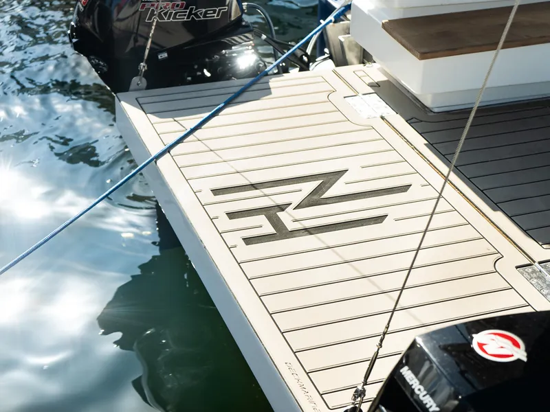 Slide: The Image of 2024 Navisyo Homes 28' NAVIS V.08 boat deck with logo, docked on water. - 22