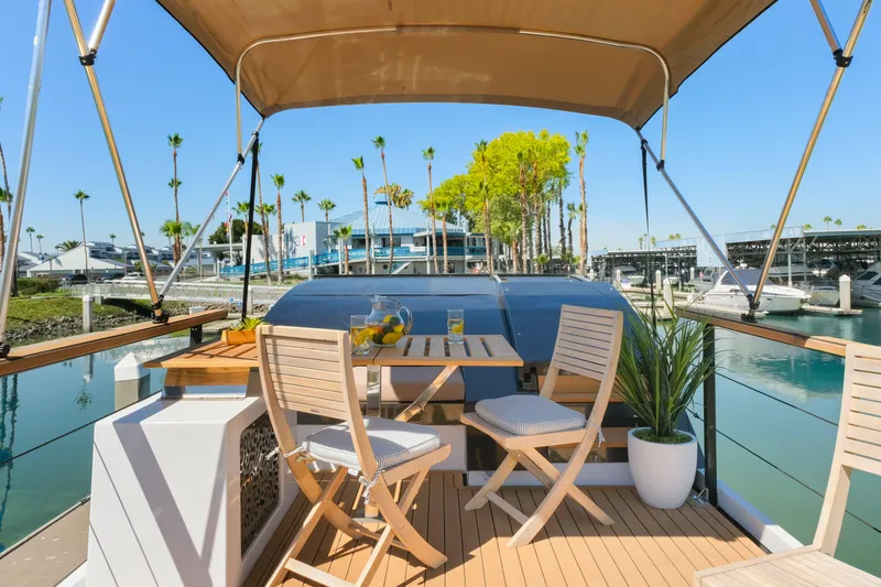 Slide: The Image of Luxurious 2024 Navisyo Homes 28' NAVIS V.08 yacht deck with seating and marina view. - 4