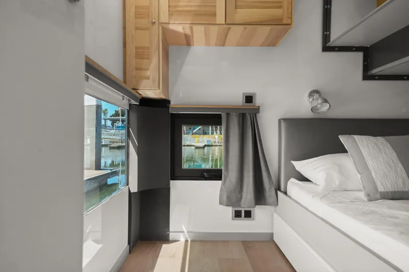 Slide: The Image of Modern interior of 2024 Navisyo Homes 28' NAVIS V.08 with bed and window view. - 42