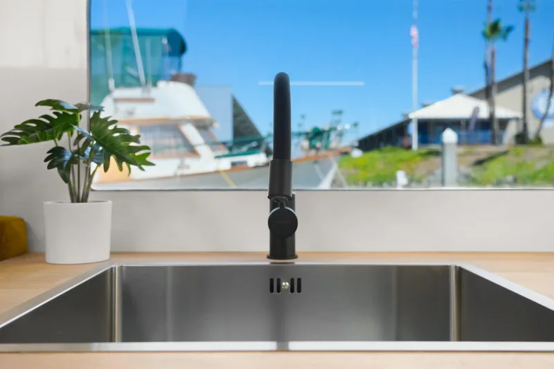 Slide: The Image of Modern kitchen sink with a sleek faucet in a 2024 Navisyo Homes 28' NAVIS V.08. - 47