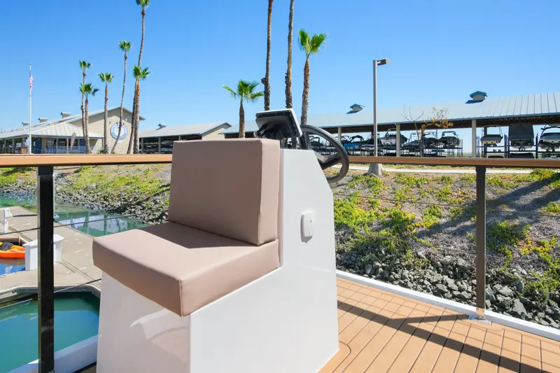 Slide: The Image of 2024 Navisyo Homes 28' NAVIS V.08 helm seat with marina view. - 8