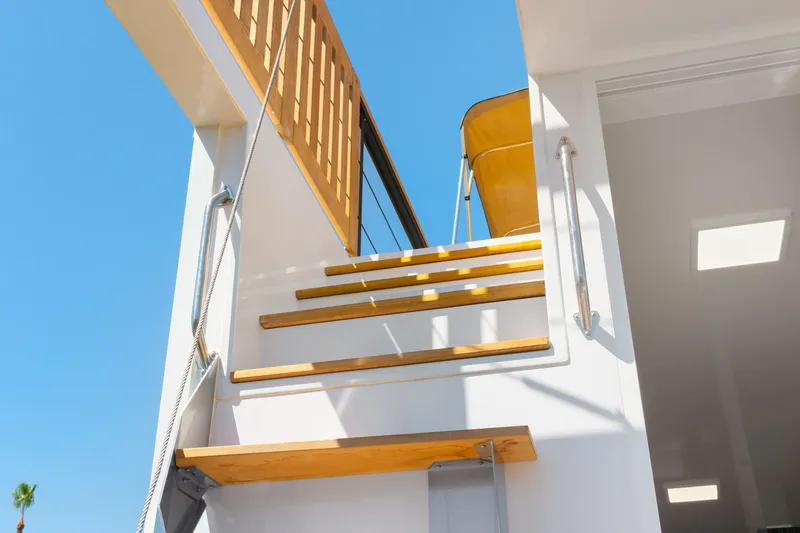 Slide: The Image of Modern 2024 Navisyo Homes 28' NAVIS V.08 yacht with wooden stairs and sleek design. - 9