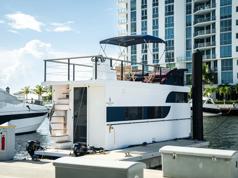 Slide: The Image of Modern 2024 Navisyo Homes 28' NAVIS V.08 houseboat docked by waterfront skyscrapers. - 23