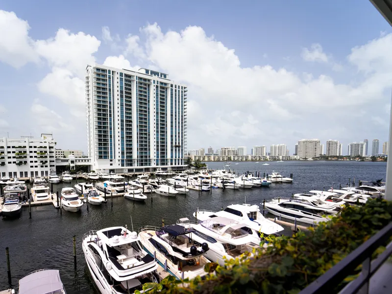 Slide: The Image of Marina with luxury yachts, including 2024 Navisyo Homes 28' NAVIS V.08, against city skyline. - 29